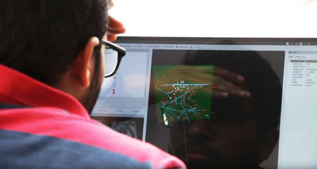 Asian Developer Looking Screen to Develop Pattern for Drone Graffiti