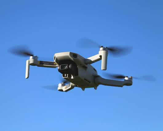 Mini Mavic Quadcopter Flying under Blue Sky